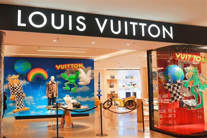 PARIS-APR 15: Customers Are On Queue To Enter Louis Vuitton Shop